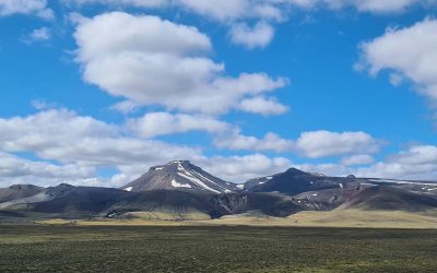 Dalastigur-blue-skies-fluffy-clouds-over-mountain-top-1680x840-2