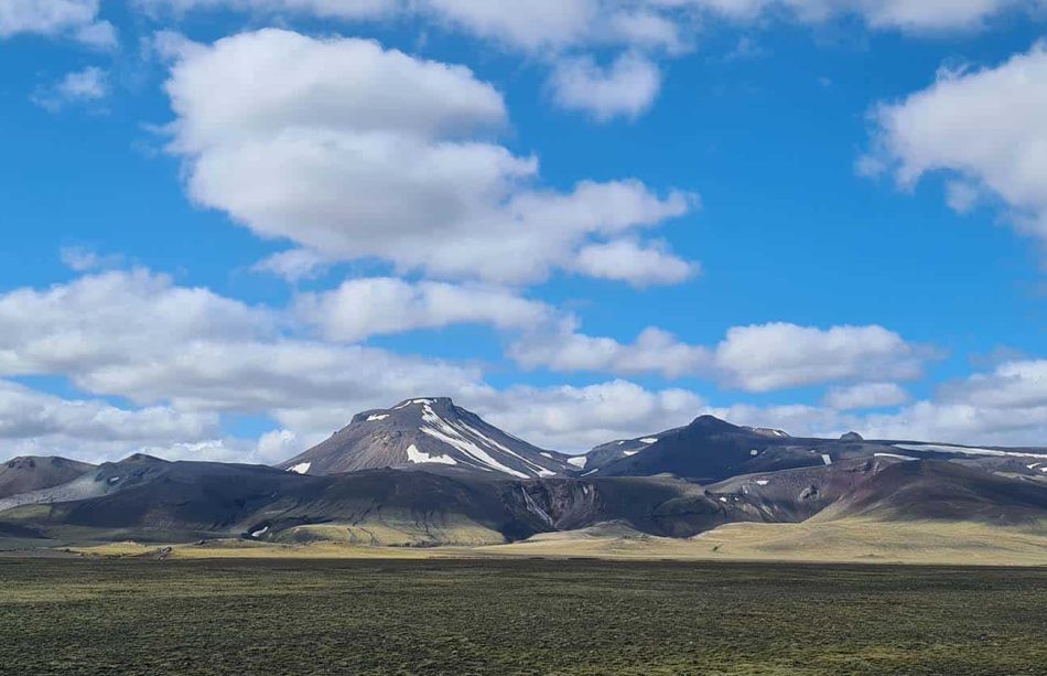 Dalastigur-blue-skies-fluffy-clouds-over-mountain-top-1680x840-2