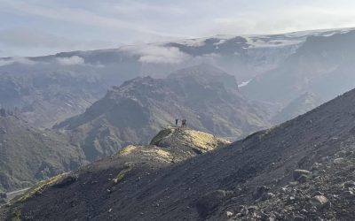 Hikers on a mountain ridge in Iceland with scenic mountain views.