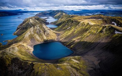 Scenic aerial view of volcanic crater lakes and green hills in Iceland.