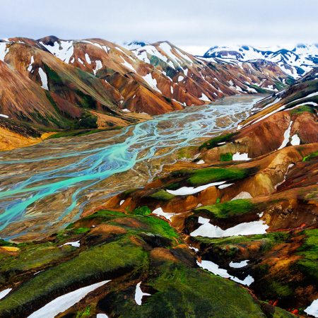 Aerial view landscape of Landmannalaugar surreal nature scenery in highland of Iceland, Europe. Beautiful colorful snow mountain terrain famous for summer trekking adventure and outdoor walking.