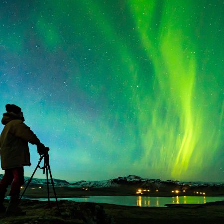 Northern-Lights_Woman-taking-photo-at-Reynisfjara-Black-Sand-Beach_Photographer-Snorri-Thor-Tryggvason_x-large1680x840