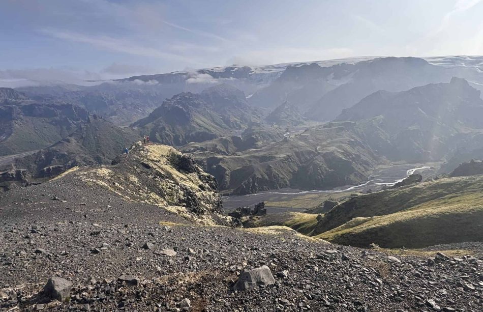 Scenic view of Fimmvorduhals mountains and valleys with rugged terrain and distant snow-capped peaks.