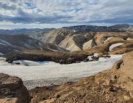 Rhyolite mountain panorama with snowfields near Hrafntinnusker on Day 02 of the Laugavegur Trek
