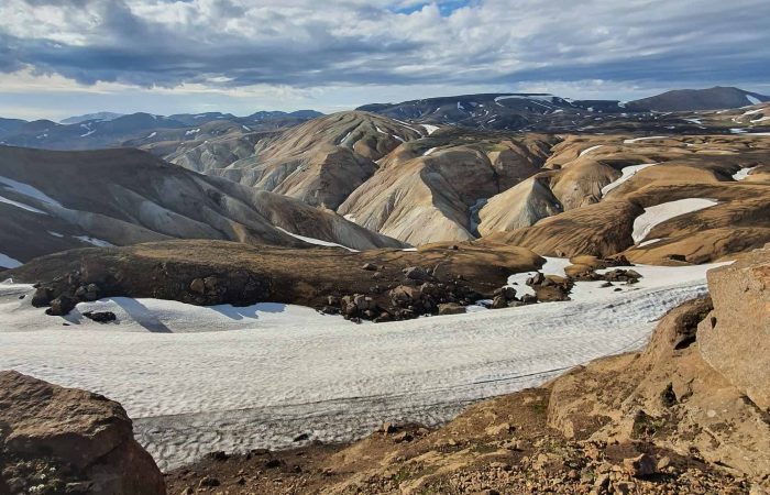 Rhyolite mountain panorama with snowfields near Hrafntinnusker on Day 02 of the Laugavegur Trek