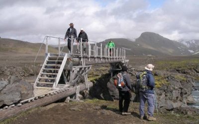 Trekkers crossing a footbridge on Day 03 of the Laugavegur Trek on the way to Emstur
