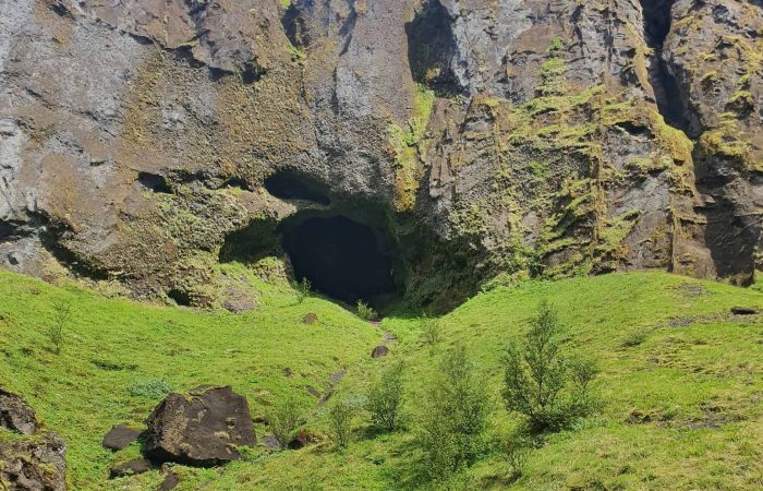 Moss-covered cliffs and volcanic cave in Þórsmörk Valley on Day 05 of the Laugavegur Trek